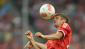 Thomas Mueller hat-trick eases Cup holders Bayern through