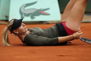 Sharapova struggles through at chilly French Open