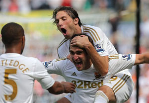 Fletcher double ends Swansea's perfect start