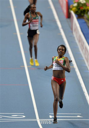 Tirunesh Dibaba makes it treble gold with 10,000m victory at world athletics